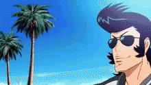 a man wearing sunglasses is standing in front of palm trees.gif